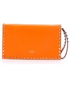 Valentino Pre-Owned: Orange Leather 'Rockstud' Studded Wristlet Clutch - Lyst