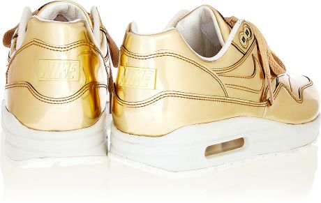 gold and white nike sneakers