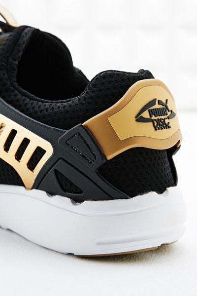 black and gold pumas for men