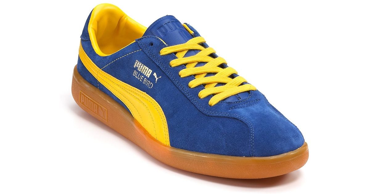 blue and yellow puma trainers