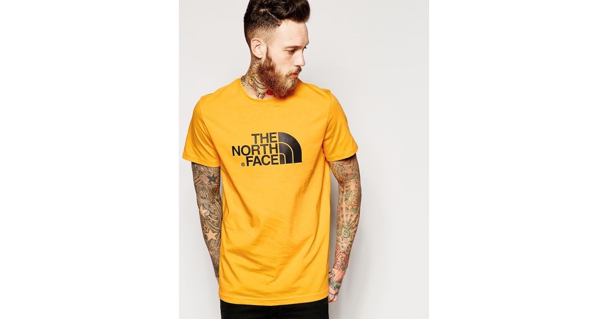 black and yellow north face t shirt