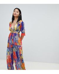 ASOS Asos Design Petite Chiffon Plunge Beach Jumpsuit In Tropical Tile Print - Multicolour