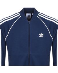 navy blue and red adidas jacket