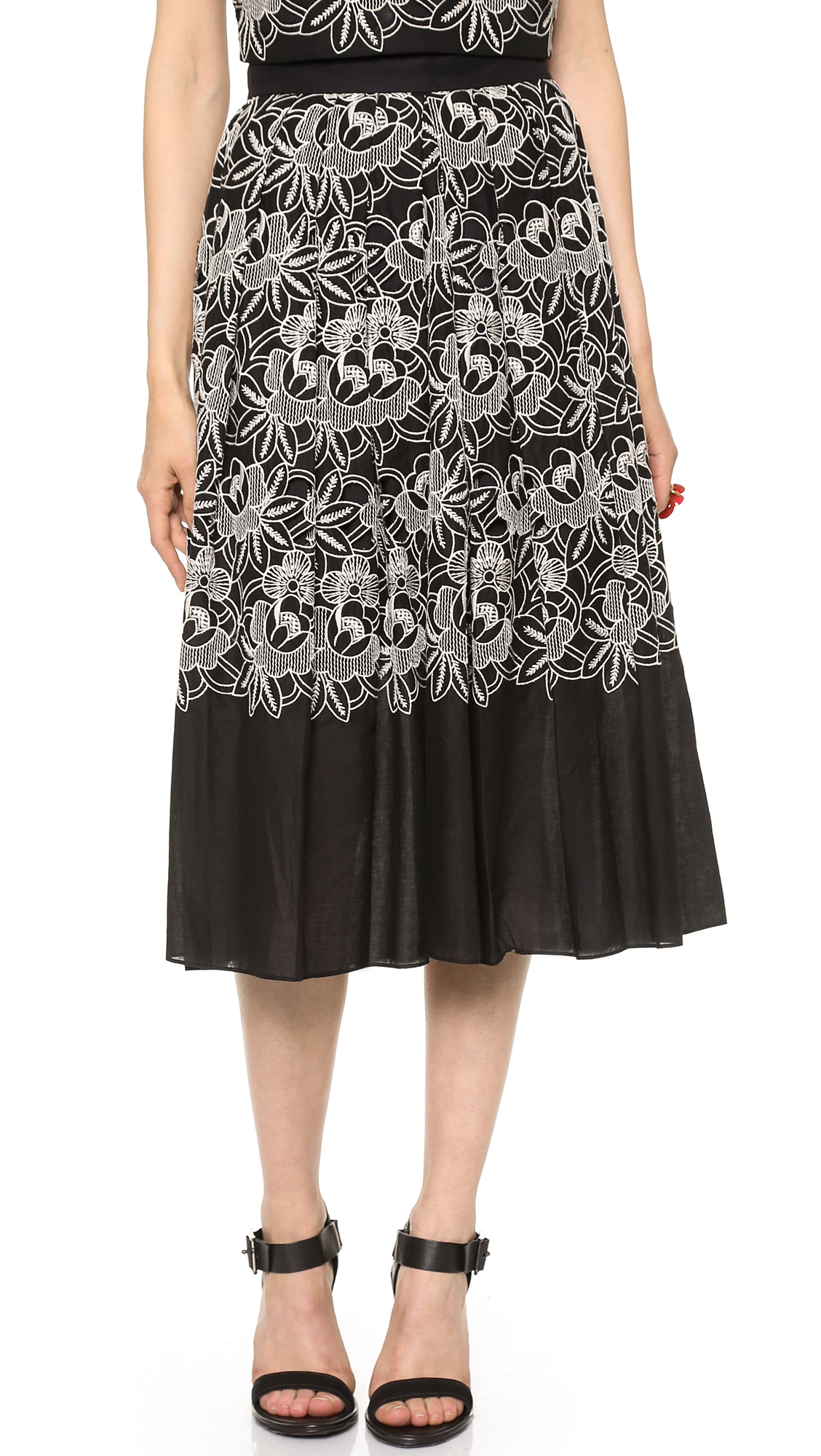 Black eyelet skirt Black Eyelet Skirt: Travel. This loft eyelet ruffle wrap skirt was my gateway black eyelet skirt. The ruffle and wrap detail were what sold me. Both were just so feminine that it got me to reconsider a black skirt for summer.