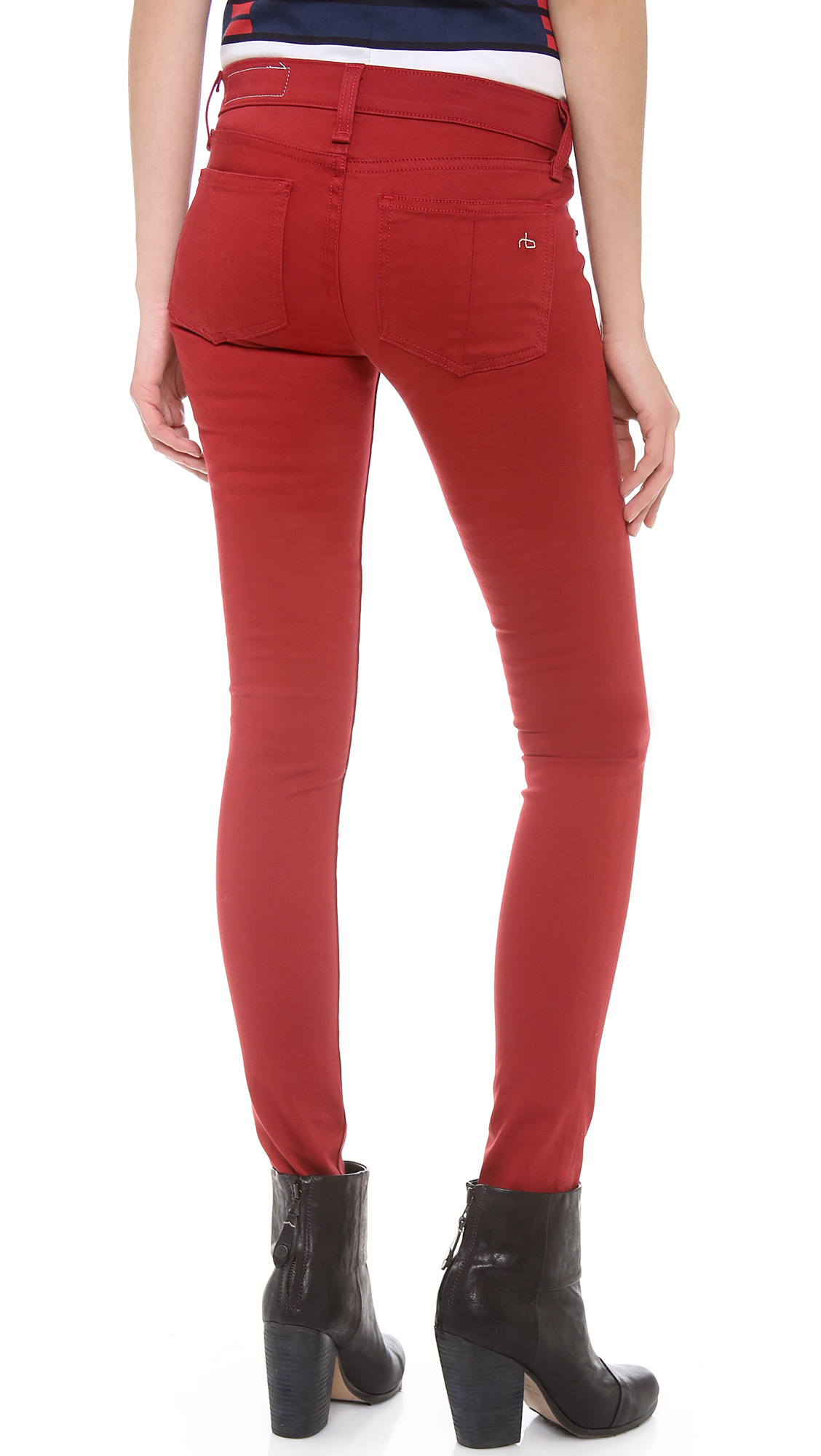 A model wearing red sateen jeans with a slight flare