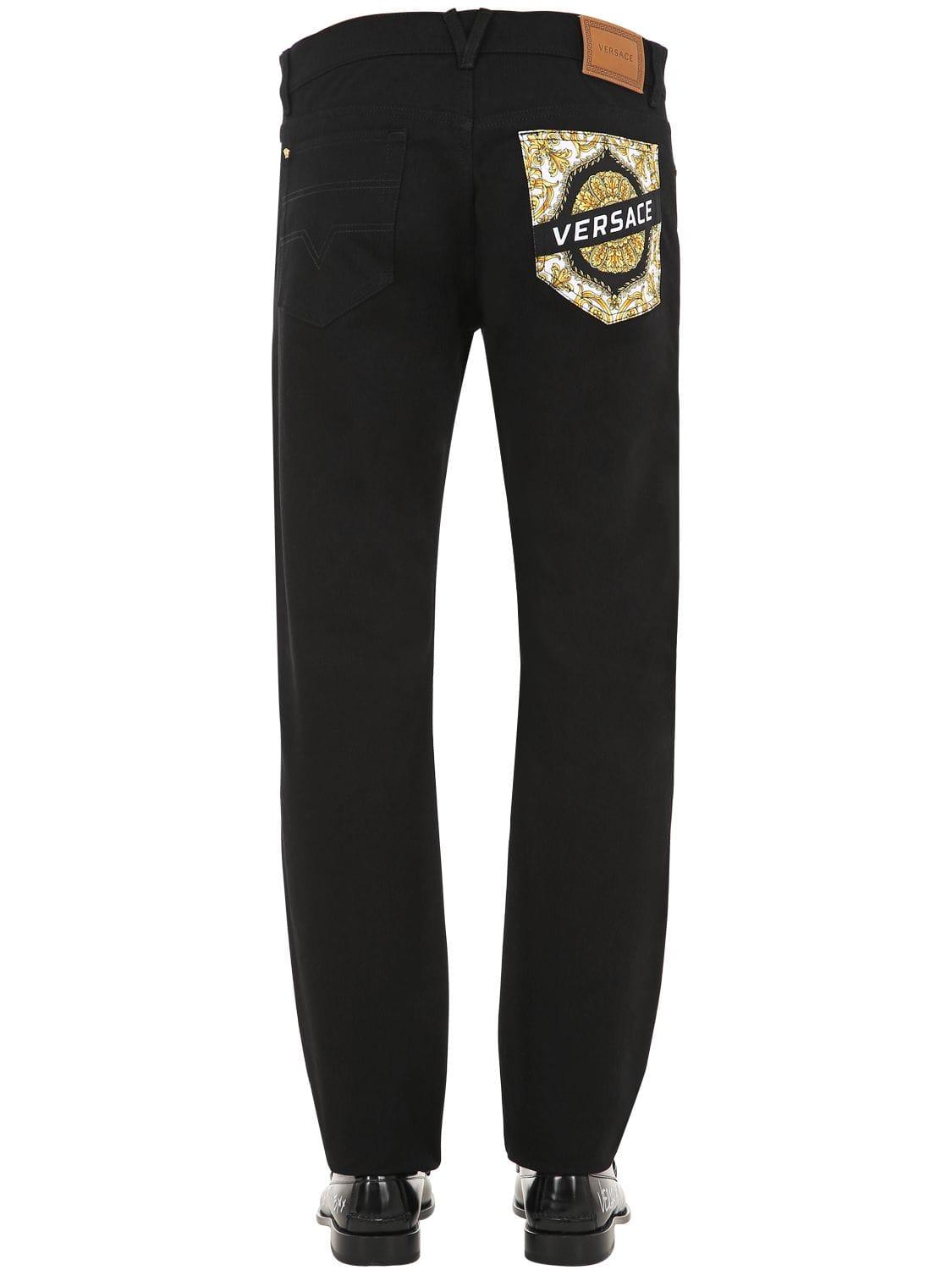 Lyst - Versace 17mm Logo Cotton Denim Jeans in Black for Men