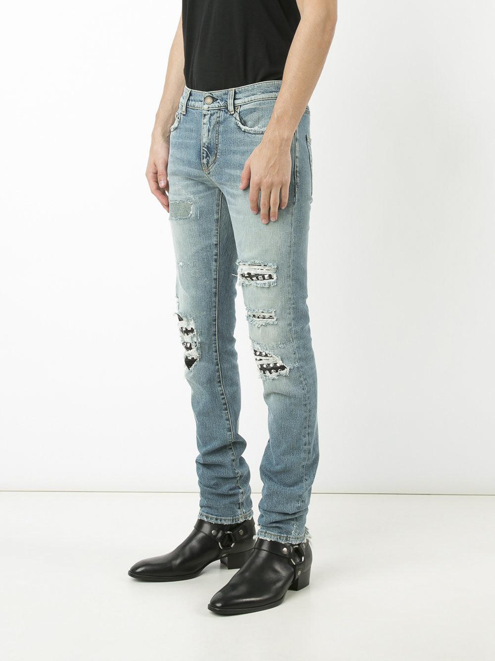 Lyst - Saint Laurent Studded Distressed Jeans in Blue for Men