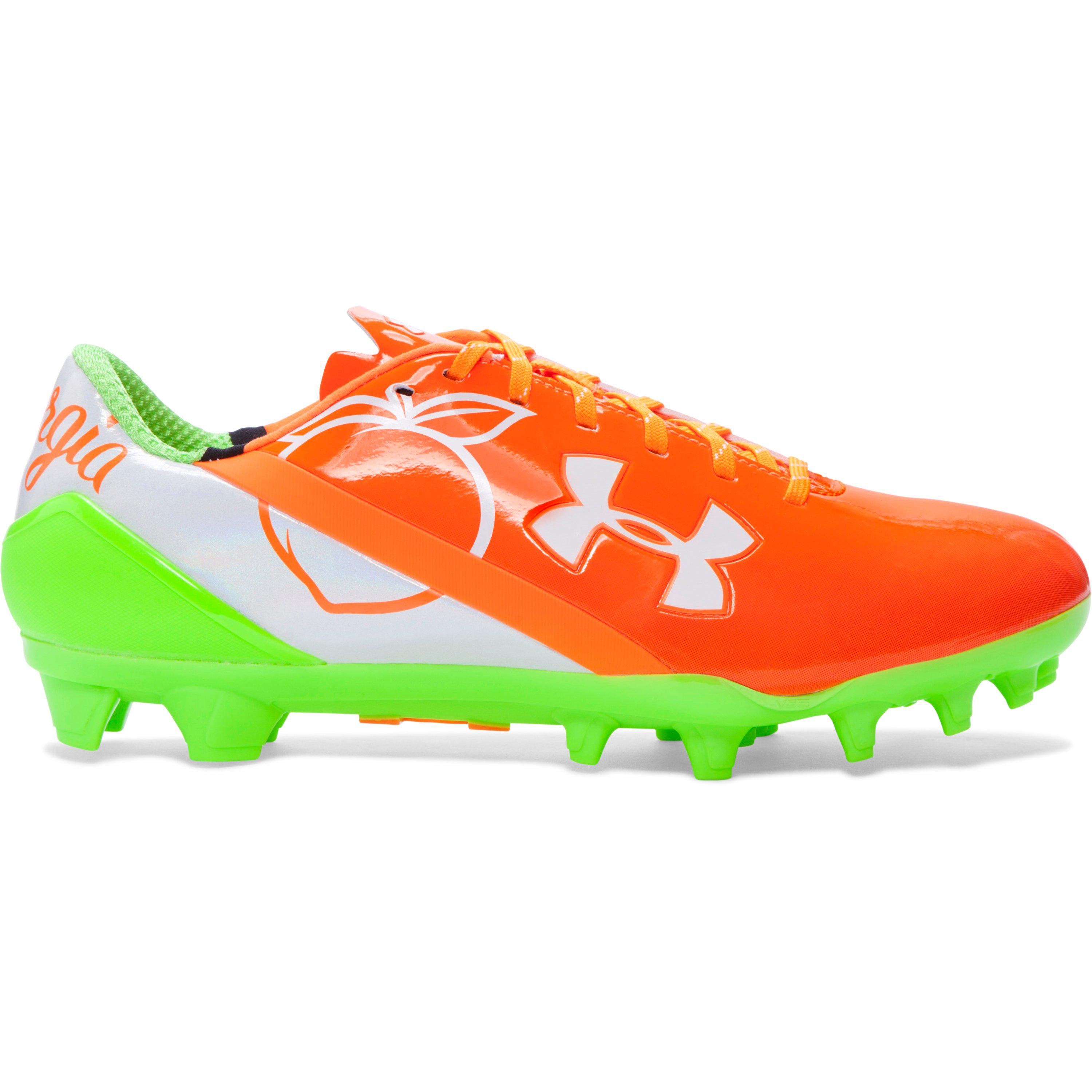 orange and white under armour football cleats